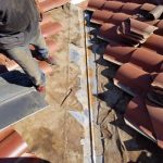Tile roof being repaired by Hickox roofing